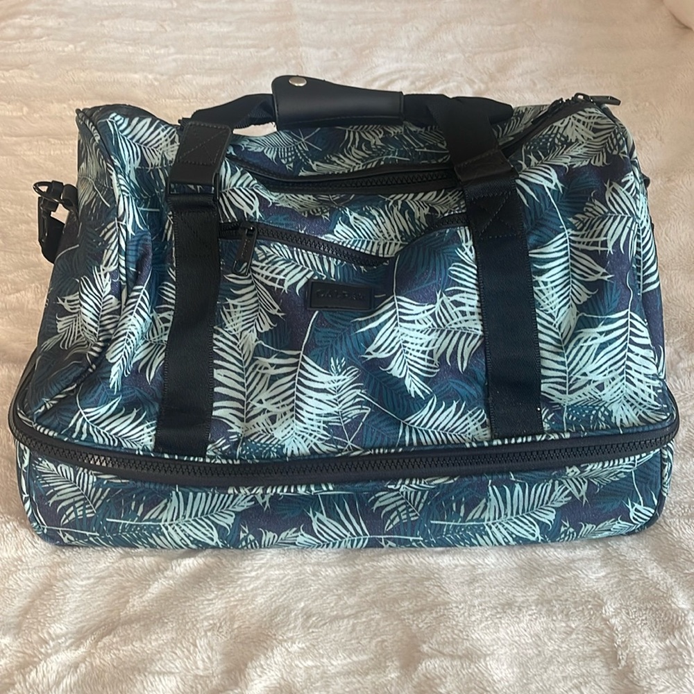 Calpak. Travel tote or weekender tote bag. Tropical print, blue and green.